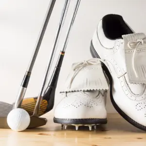 a pair of golf shoes and golf clubs